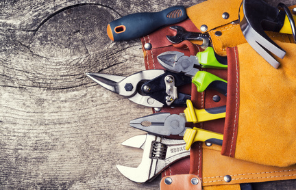 Set of tools on wooden background .